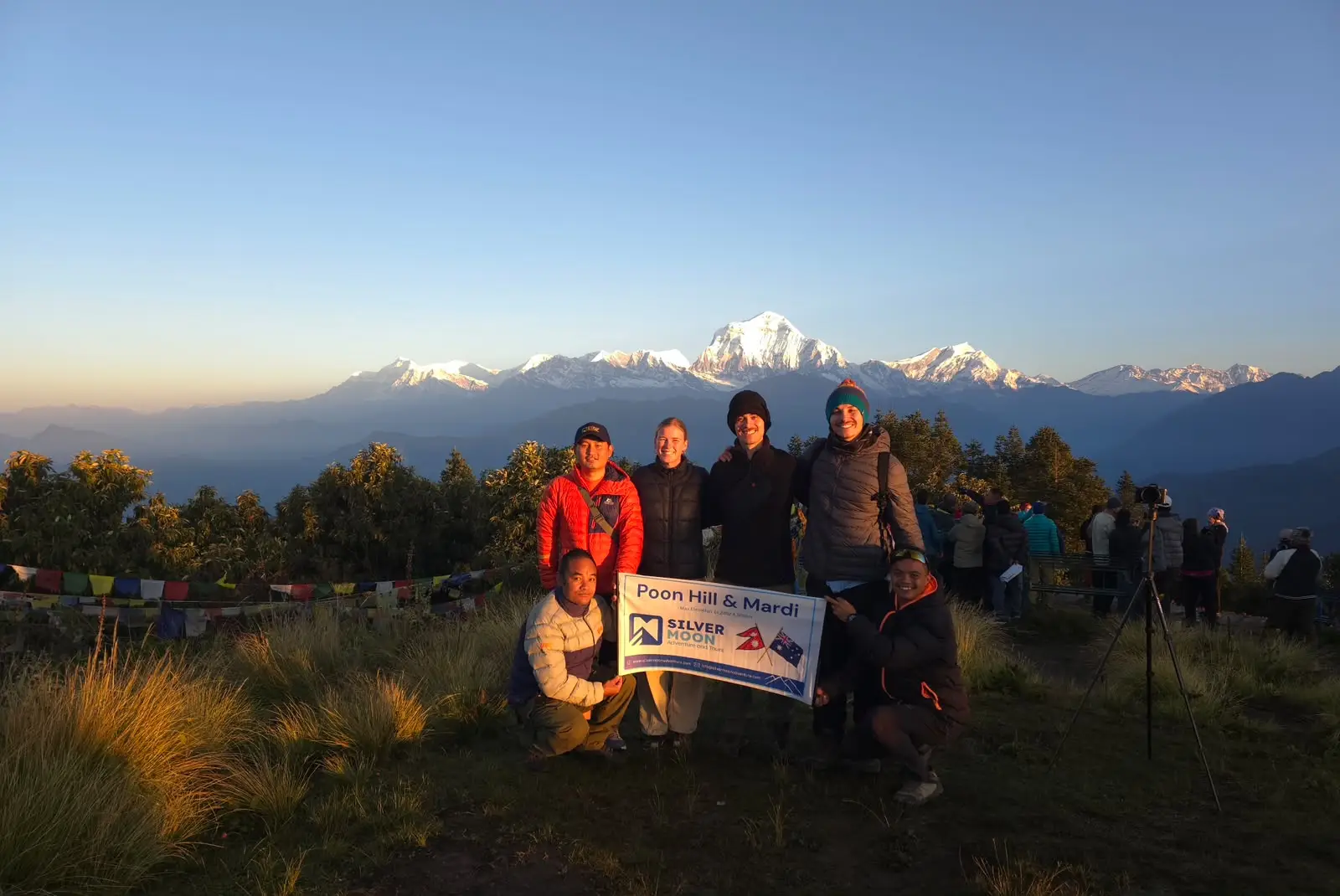 Ghorepani with Mardi Himal Trek-12 Days Trekking group posing at Poon Hill with the snow-covered Annapurna Himalayas at sunrise.