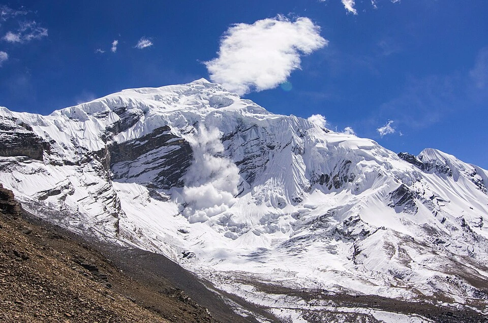 Chulu West Peak Climbing highlights the stunning, snow-covered Himalayan giant rising sharply against a bright blue sky.
