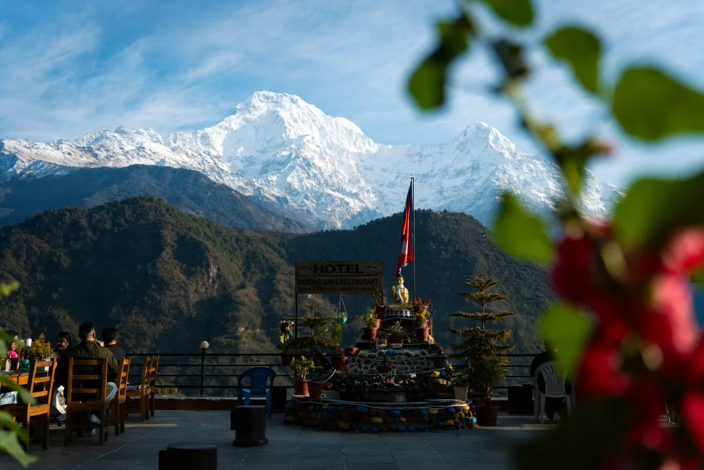 Mountain View Restaurant on the Ghorepani Ghandruk Trek Trekkers dining at a terrace hotel overlooking snow-covered Himalayan peaks along the scenic ghorepani ghandruk trek.