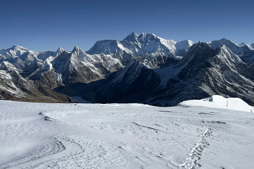 Mera Peak Climbing offers a breathtaking view from the snow-covered ridge with massive Himalayan giants towering in the background.