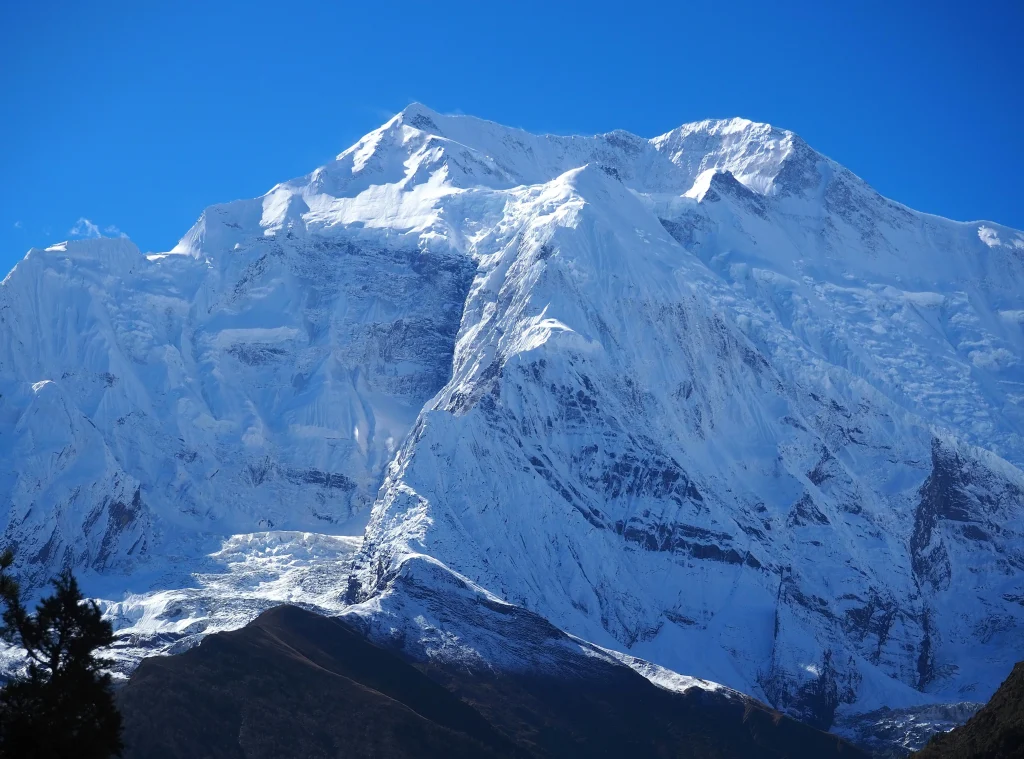 Pisang Peak Climbing showcases the stunning snow-capped summit towering above the Manang valley in the Annapurna region.