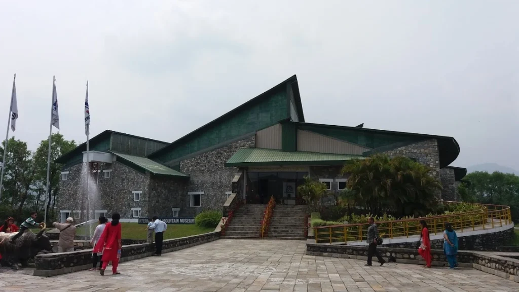 Front entrance building of the International Mountain Museum in Pokhara with stone walls and visitors on the courtyard