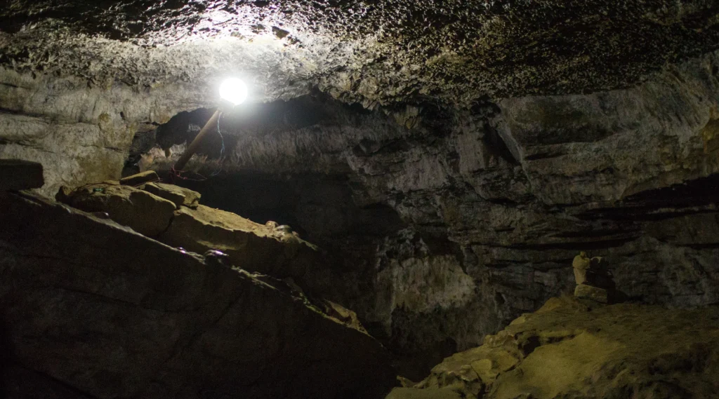 Illuminated rocky limestone interior chamber of Mahendra Cave in Pokhara.