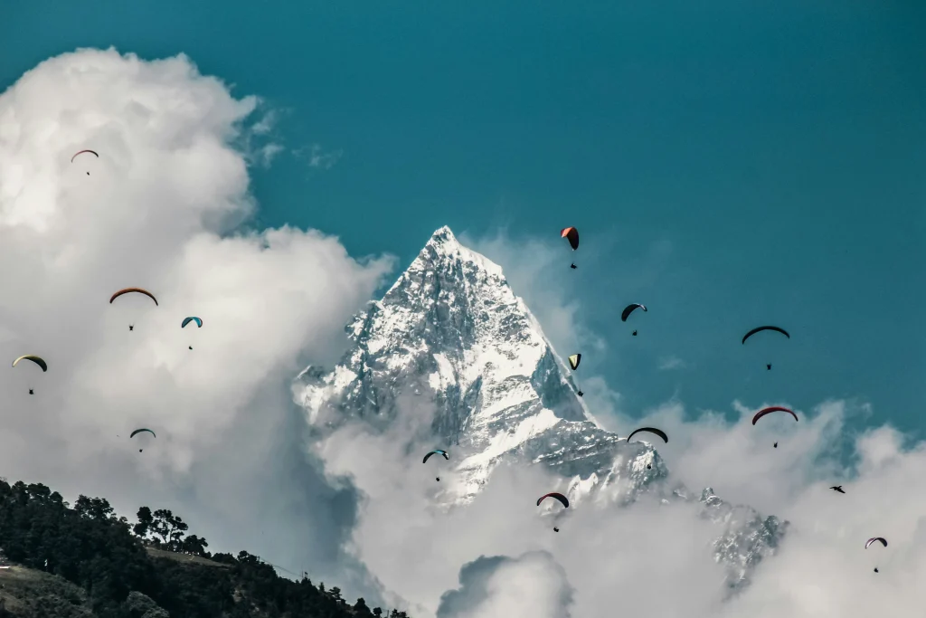 Paragliders flying over Pokhara with Himalayan mountains in Nepal