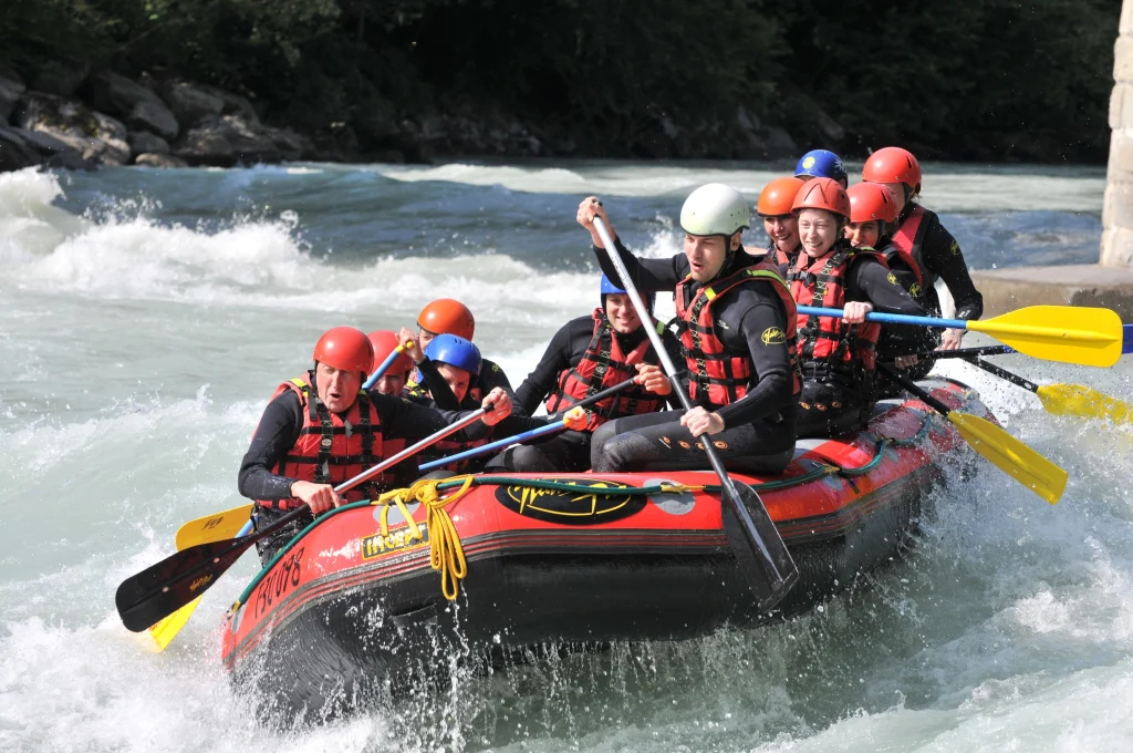 White water rafting group navigating rapids in Nepal