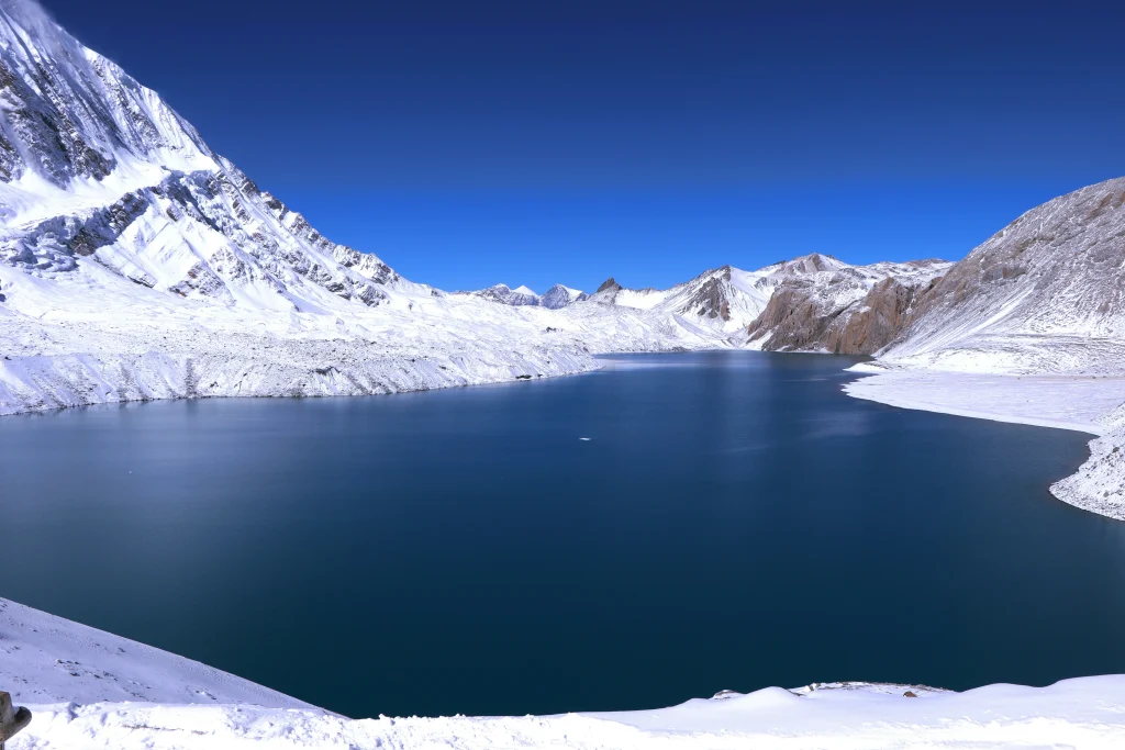 A wide landscape view of Tilicho Lake, one of the highlights of the Annapurna Circuit trek