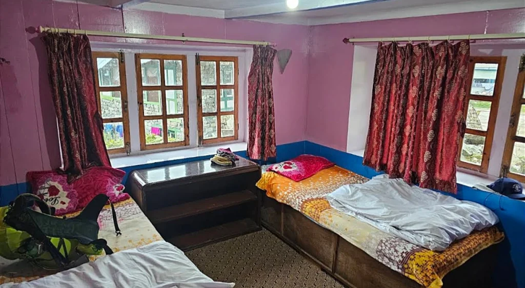 A basic twin-bed teahouse room showing simple lodging options available on a standard vs luxury ebc trek.