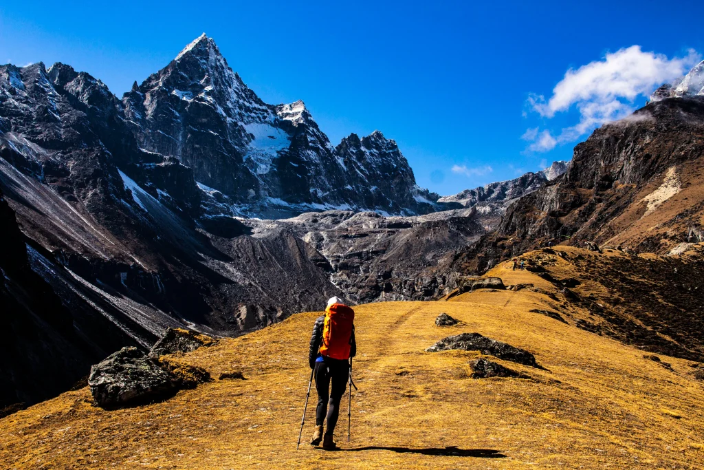 Trekker walking through the Himalayan landscape of Nepal